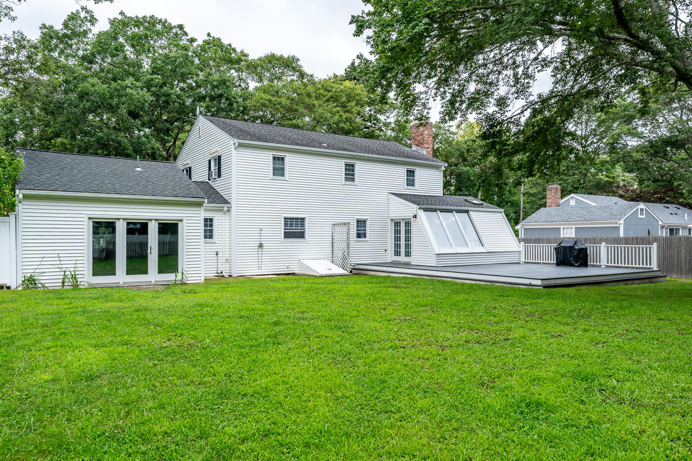 82 Skunknet Road Centerville, MA 02632 - Photo 33 of 35 a view of a house with backyard sitting area and garden