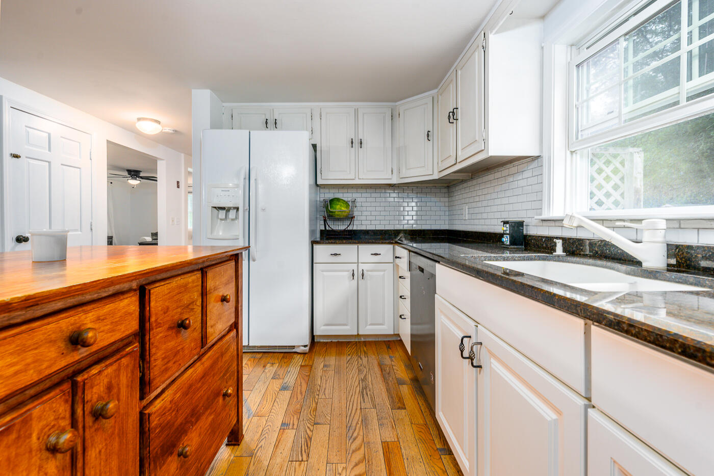 82 Skunknet Road Centerville, MA 02632 - Photo 8 of 35 a kitchen with granite countertop white cabinets white appliances and sink