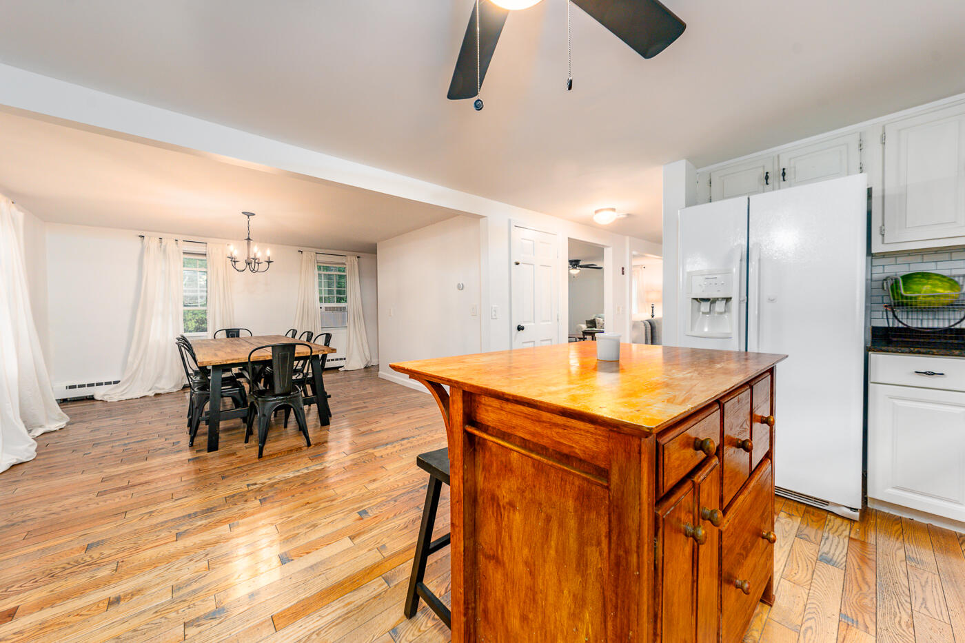82 Skunknet Road Centerville, MA 02632 - Photo 9 of 35 a dining hall with stainless steel appliances kitchen island a table and chairs in it