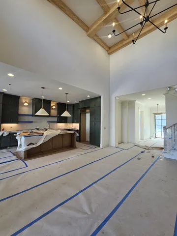 a kitchen view with stainless steel appliances kitchen island granite countertop a sink and cabinets