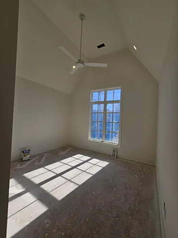 a view of a livingroom with a ceiling fan and window