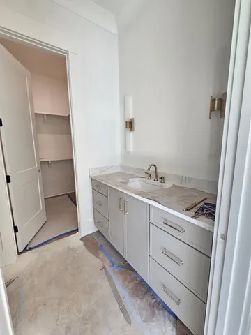 a spacious bathroom with a sink a toilet a shower and a mirror