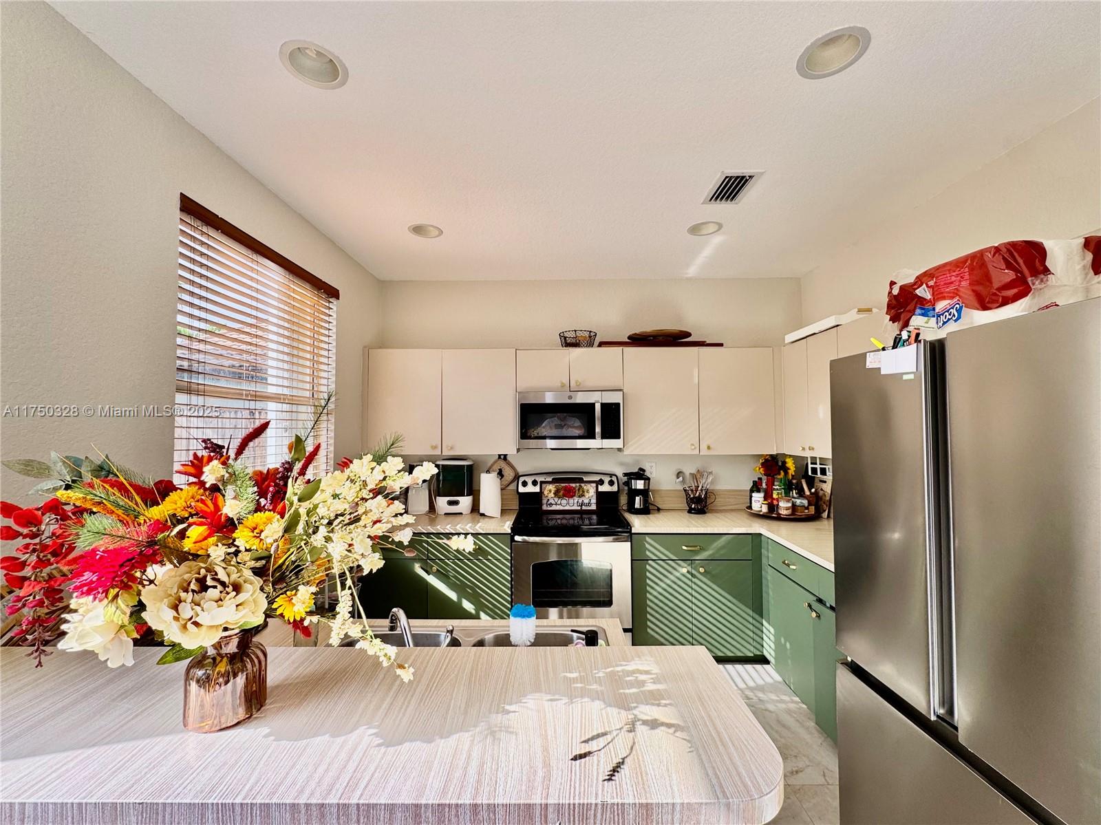 1542 Southeast 20th Road Homestead, FL 33035 - Photo 11 of 22 a kitchen with granite countertop a sink cabinets and appliances