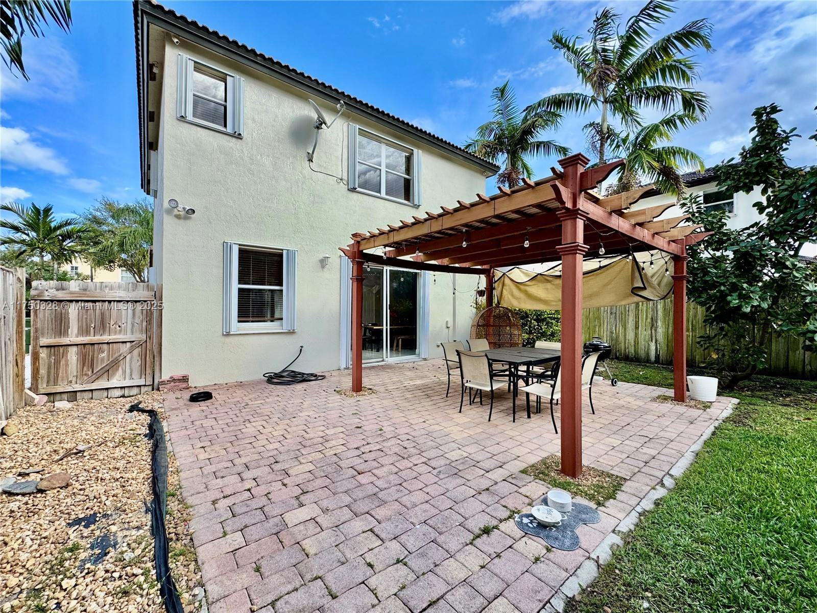 1542 Southeast 20th Road Homestead, FL 33035 - Photo 21 of 22 a patio with a table and chairs