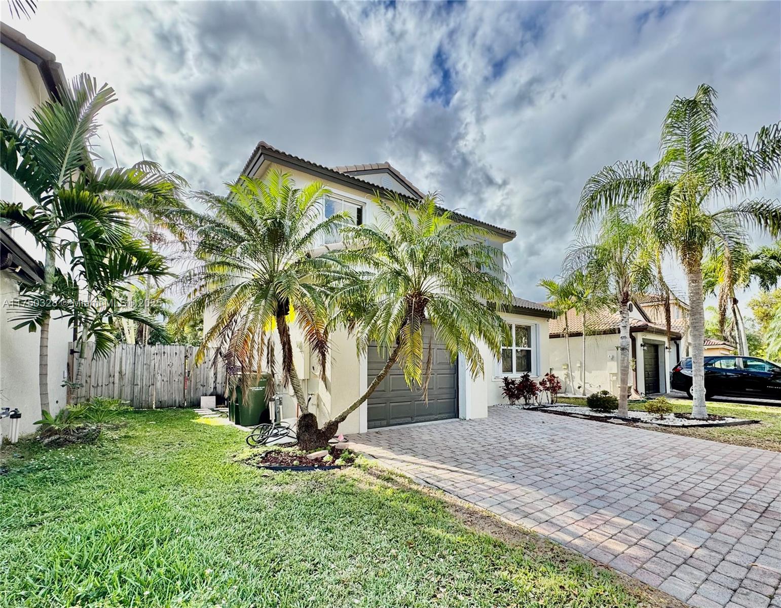 1542 Southeast 20th Road Homestead, FL 33035 - Photo 5 of 22 a palm tree sitting in front of a house with a big yard