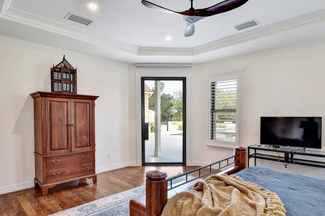 a view of swimming pool with outdoor seating and house in the background