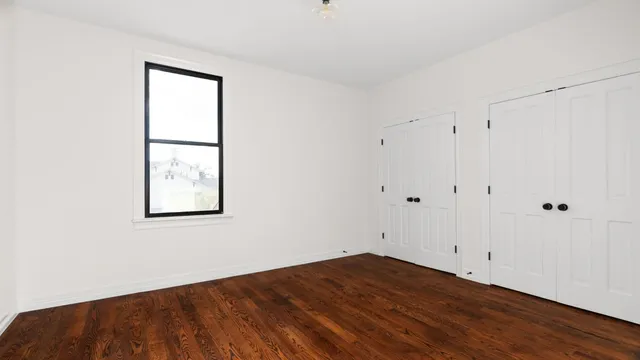 a bathroom with a granite countertop sink a mirror and a shower