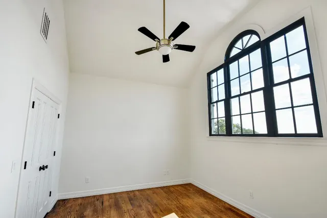 a view of small space with wooden floor and a window