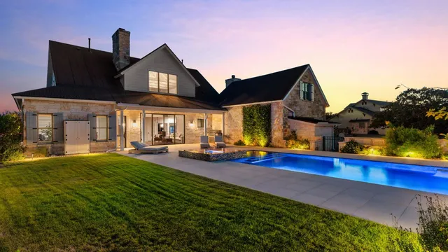 a view of a house with swimming pool and sitting area
