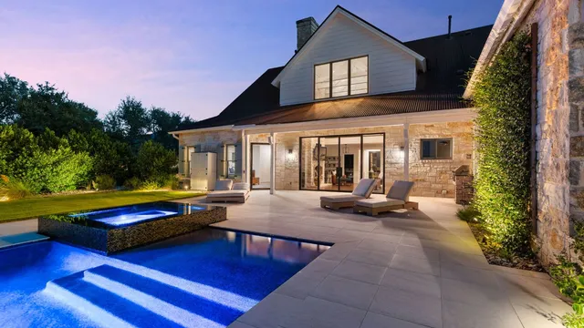 a view of a house with swimming pool and sitting area