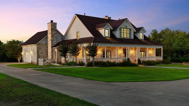 a front view of a house with a garden and deck