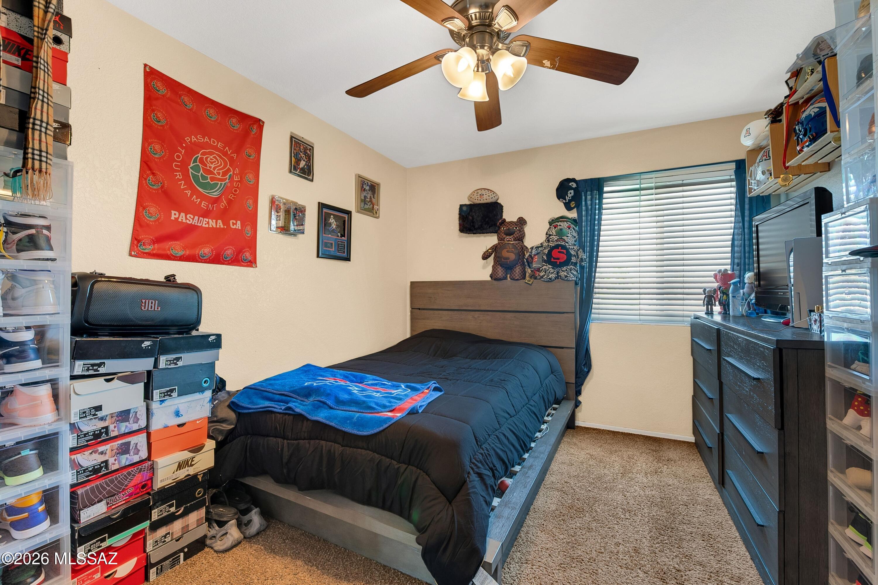 7159 West Maple Ridge Drive Tucson, AZ 85743 - Photo 23 of 42 a bedroom with a bed and a flat screen tv