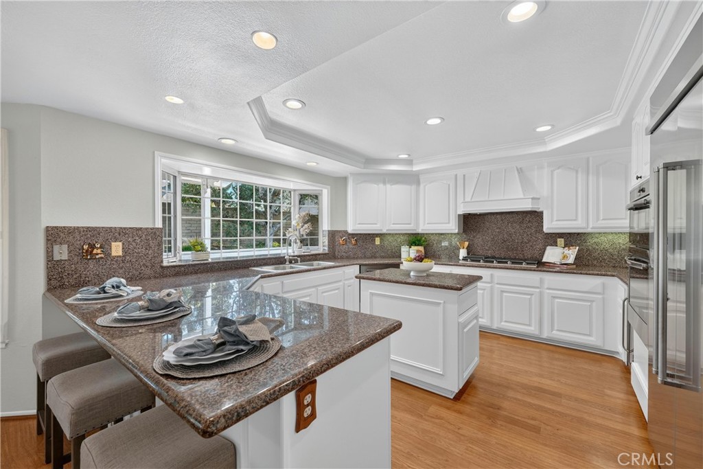 2935 Bluebell Avenue Brea, CA 92821 - Photo 8 of 38 Beautiful kitchen with granite countertops, breakfast bar, stainless steel appliances, and an oversized refrigerator