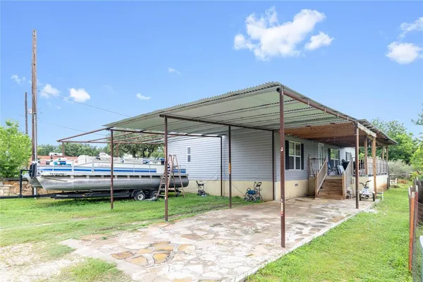 a backyard of a house with table and chairs