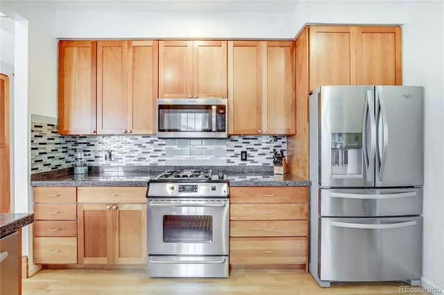 a kitchen with stainless steel appliances granite countertop a stove and a sink
