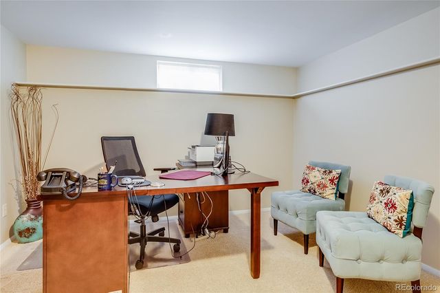 a bedroom with a bed and dresser with wooden floor
