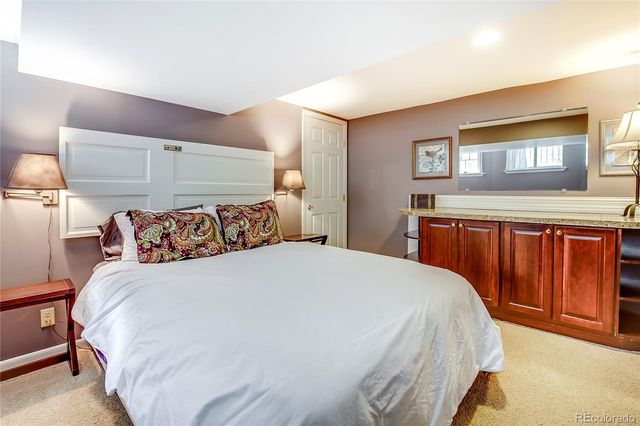 a bathroom with a tub a sink and mirror