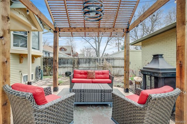 a view of a patio with table and chairs with wooden floor and plants