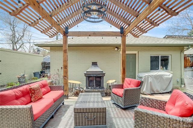 a view of a house with backyard and sitting area