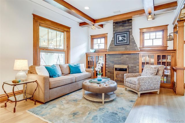 a dining room with furniture a chandelier and wooden floor
