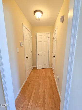 a view of a hallway with wooden floor