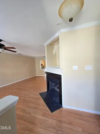 a view of a livingroom with a fireplace and wooden floor