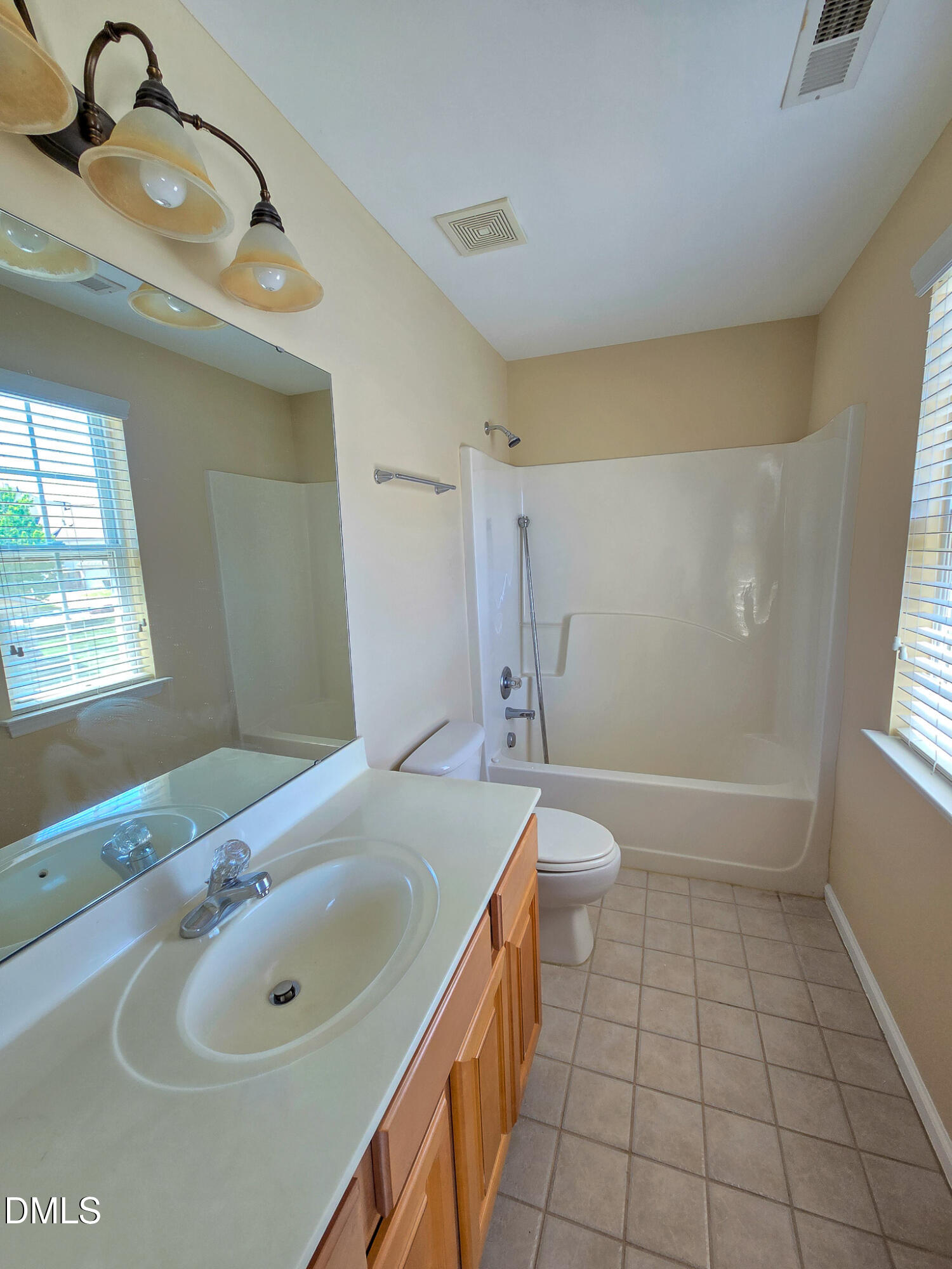 9819 Layla Avenue Raleigh, NC 27617 - Photo 21 of 35 a bathroom with a sink a toilet and shower
