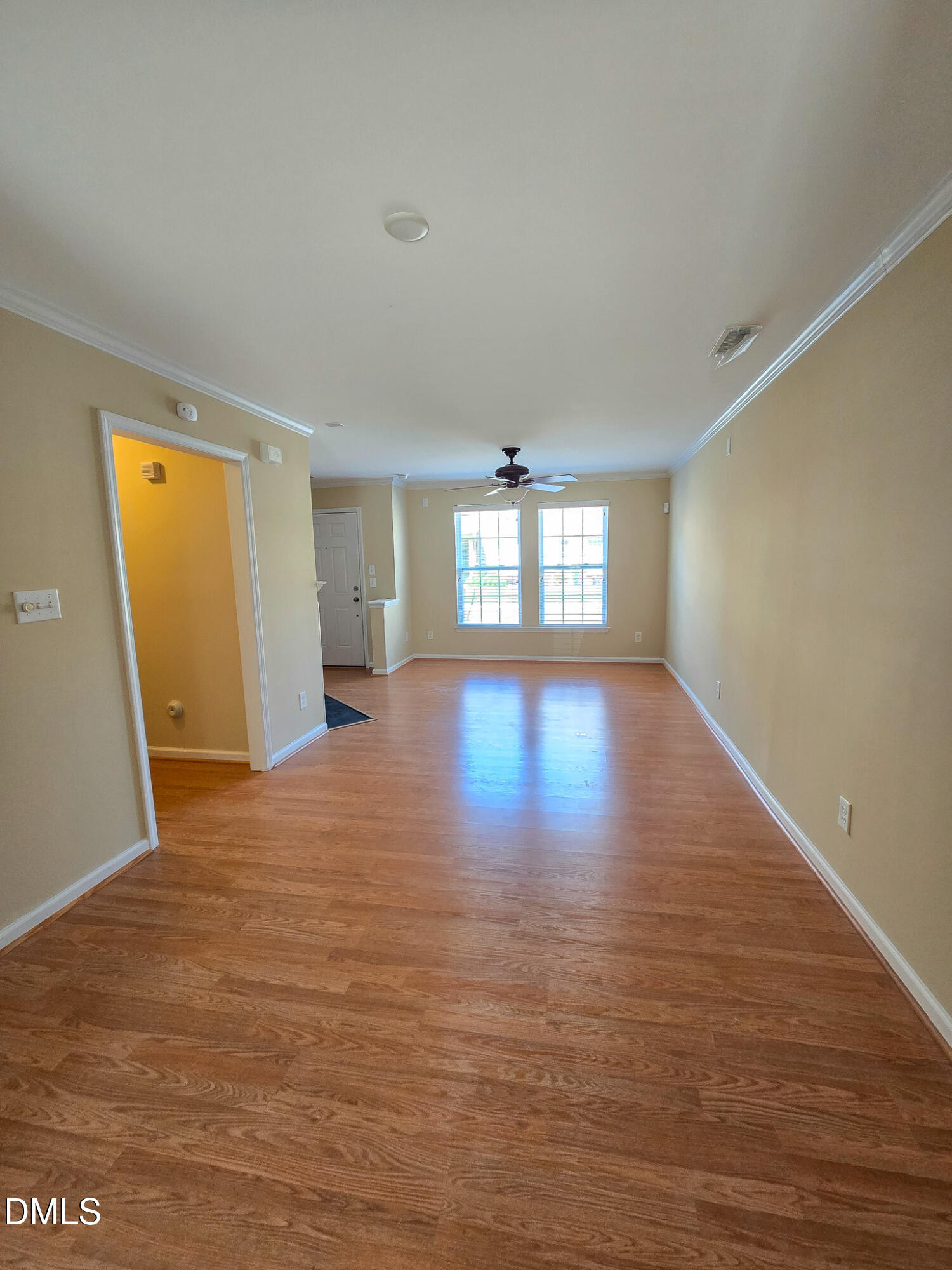 9819 Layla Avenue Raleigh, NC 27617 - Photo 8 of 35 a view of an empty room with window and wooden floor