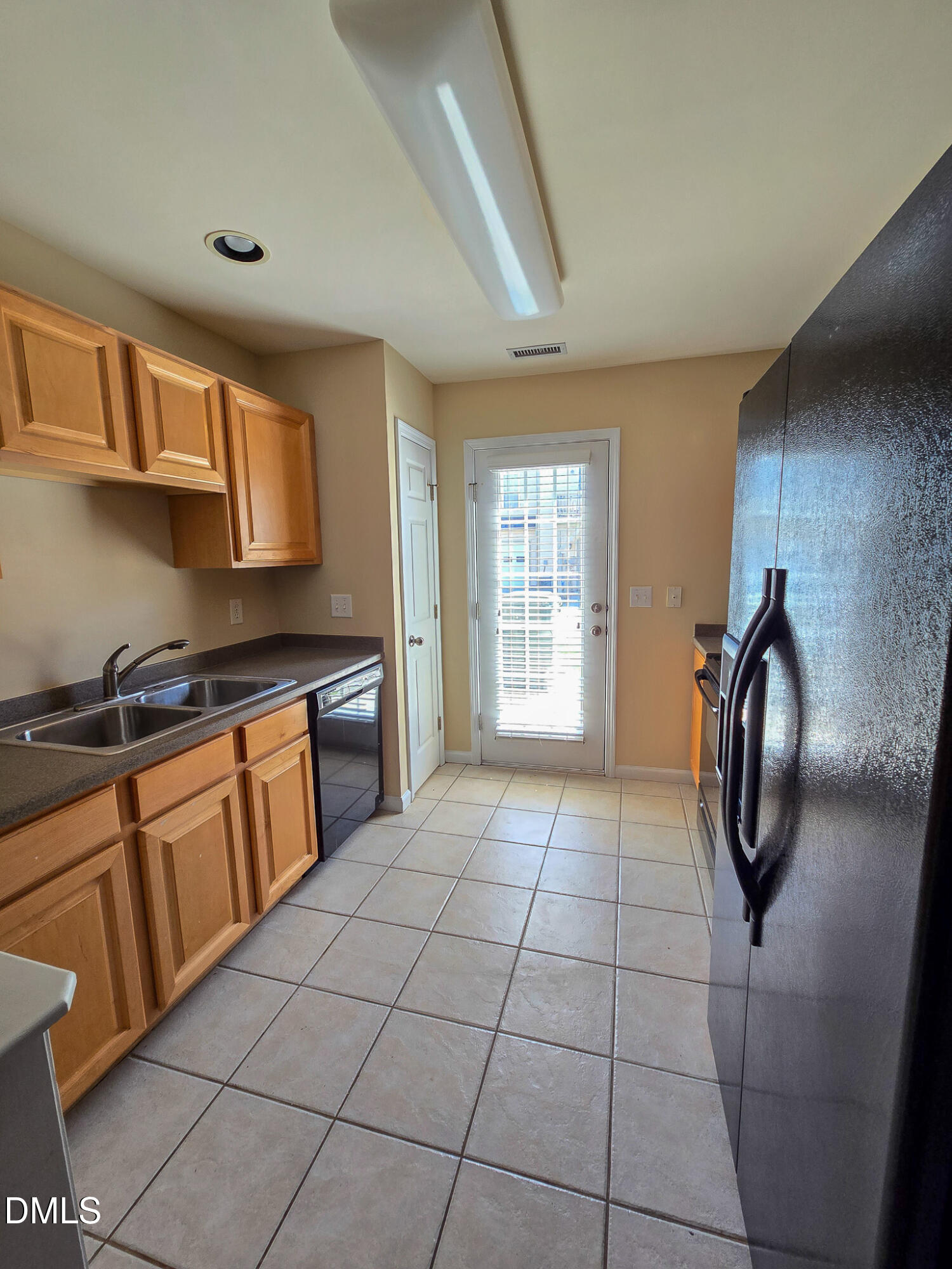 9819 Layla Avenue Raleigh, NC 27617 - Photo 9 of 35 a view of a kitchen with fridge and windows