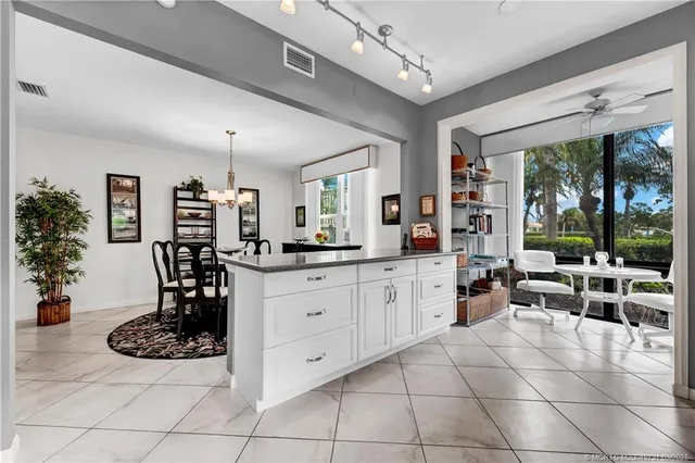 a kitchen with cabinets and chairs