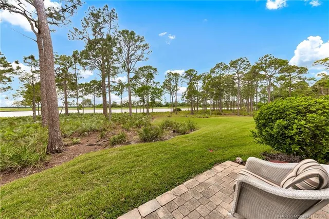 a view of a garden with lawn chairs