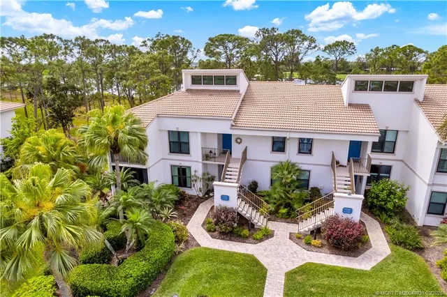 a aerial view of a house with yard and green space