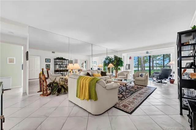 a living room with furniture and a floor to ceiling window