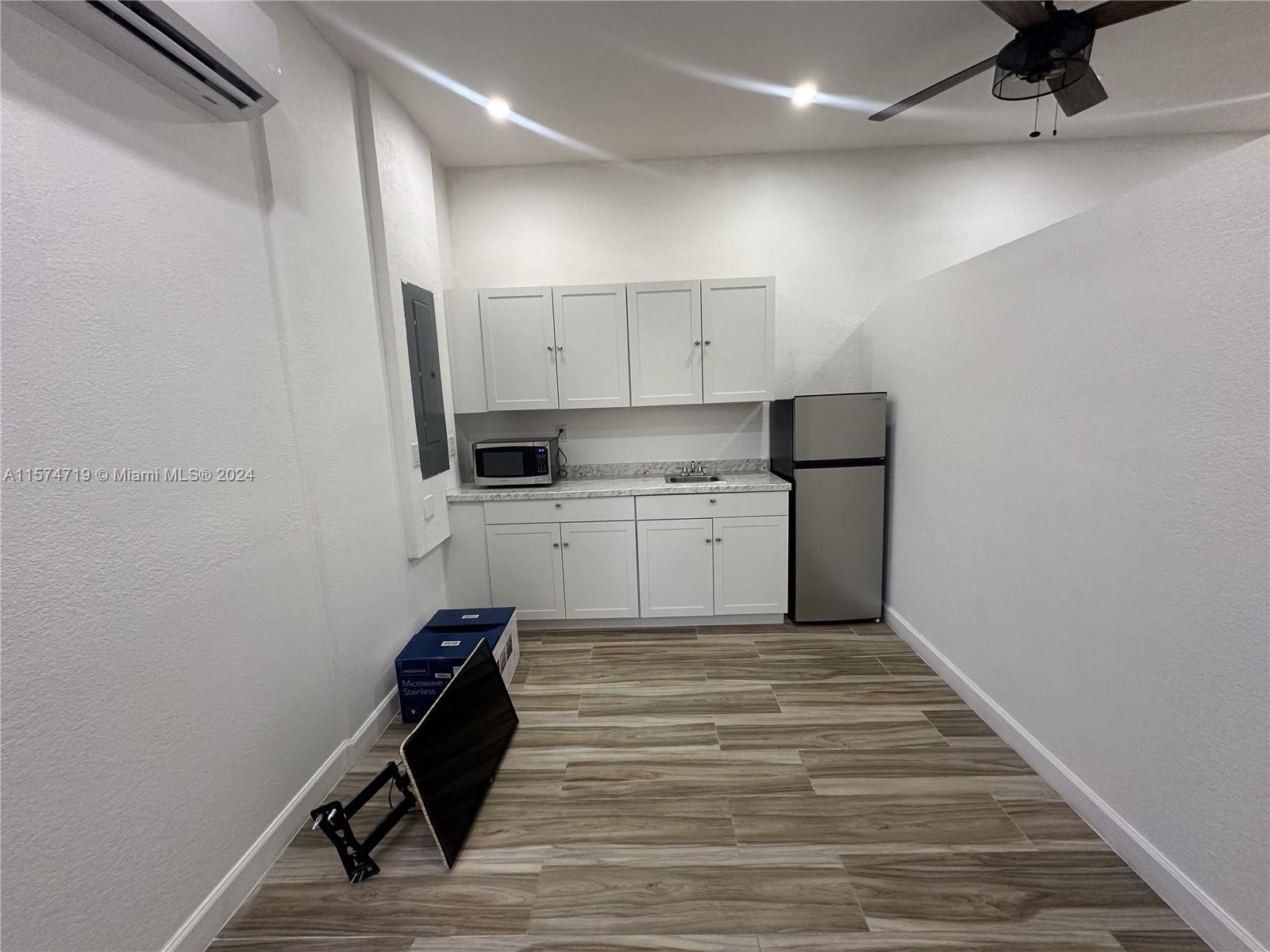 27176 Southwest 132 Ct Road, Unit 2 Homestead, FL 33032 - Photo 4 of 10 a room with cabinets and wooden floor
