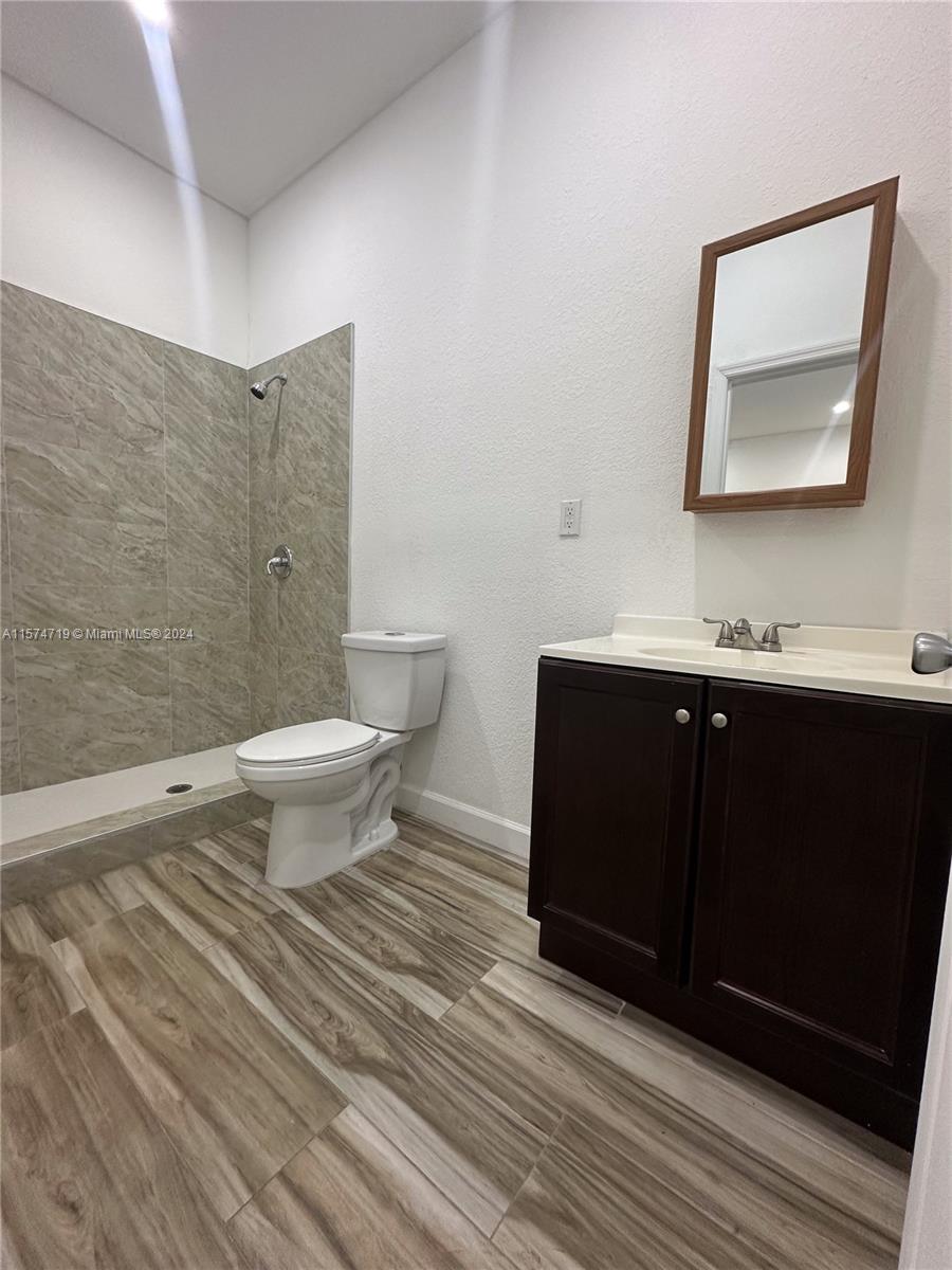 27176 Southwest 132 Ct Road, Unit 2 Homestead, FL 33032 - Photo 8 of 10 a bathroom with a sink toilet and mirror