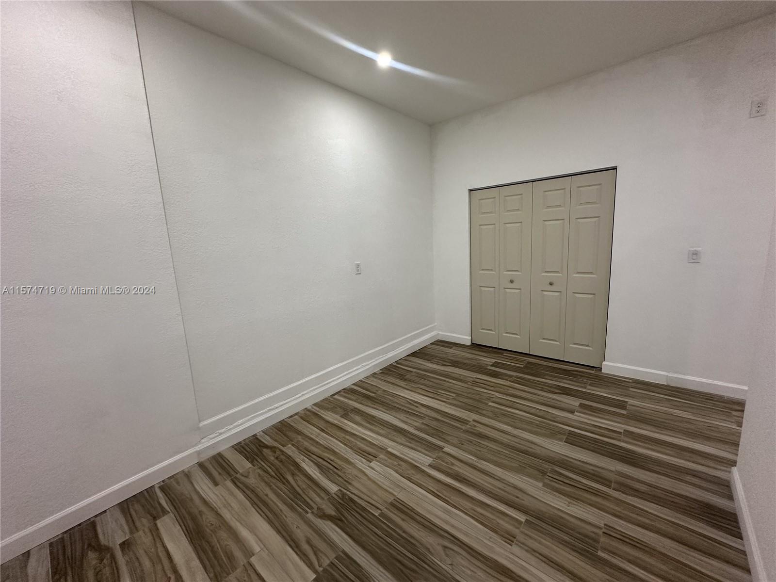 27176 Southwest 132 Ct Road, Unit 2 Homestead, FL 33032 - Photo 9 of 10 a view of a room with wooden floor