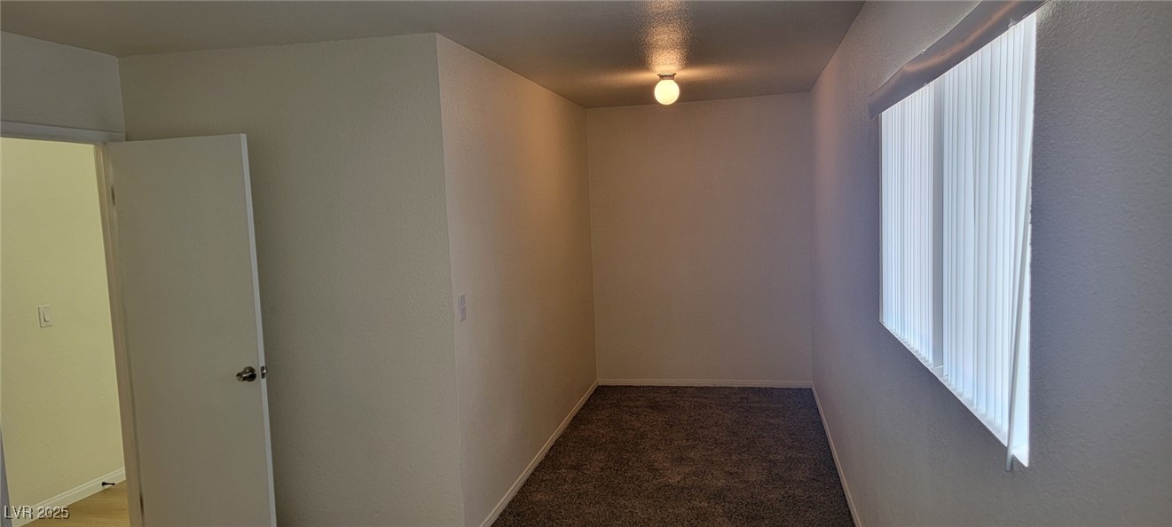 5196 Golden Lane, Unit C Las Vegas, NV 89119 - Photo 21 of 29 Empty room featuring baseboards and light carpet