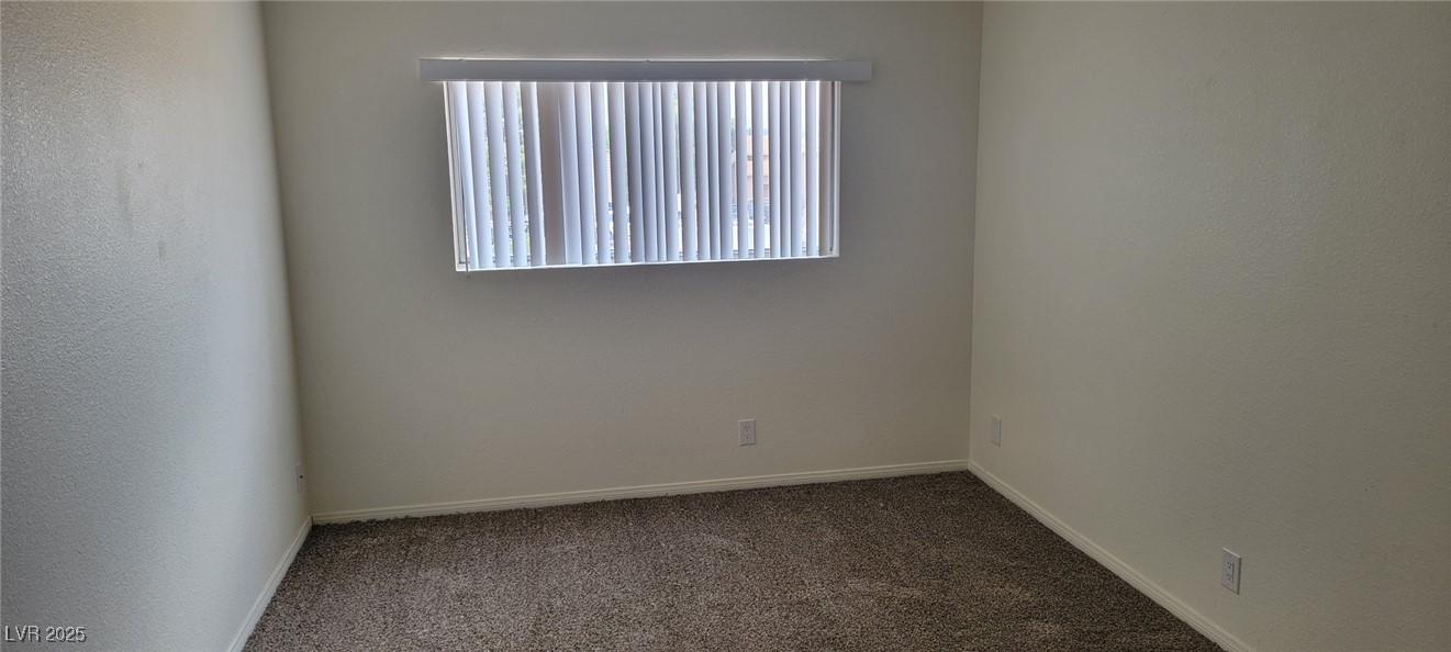 5196 Golden Lane, Unit C Las Vegas, NV 89119 - Photo 27 of 29 Empty room with dark carpet