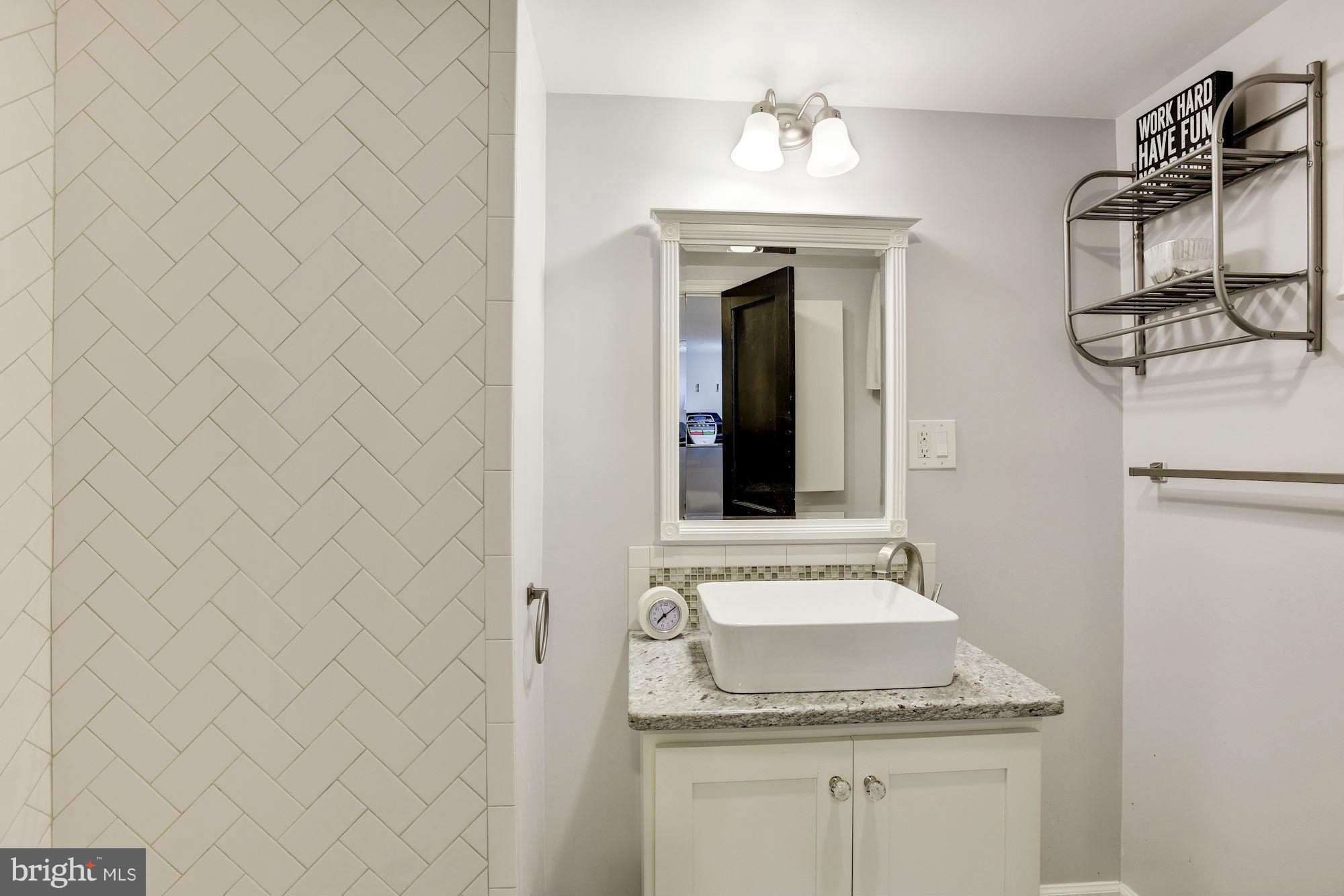 1966 Edgewood Road Baltimore, MD 21286 - Photo 22 of 26 a bathroom with a sink and a mirror