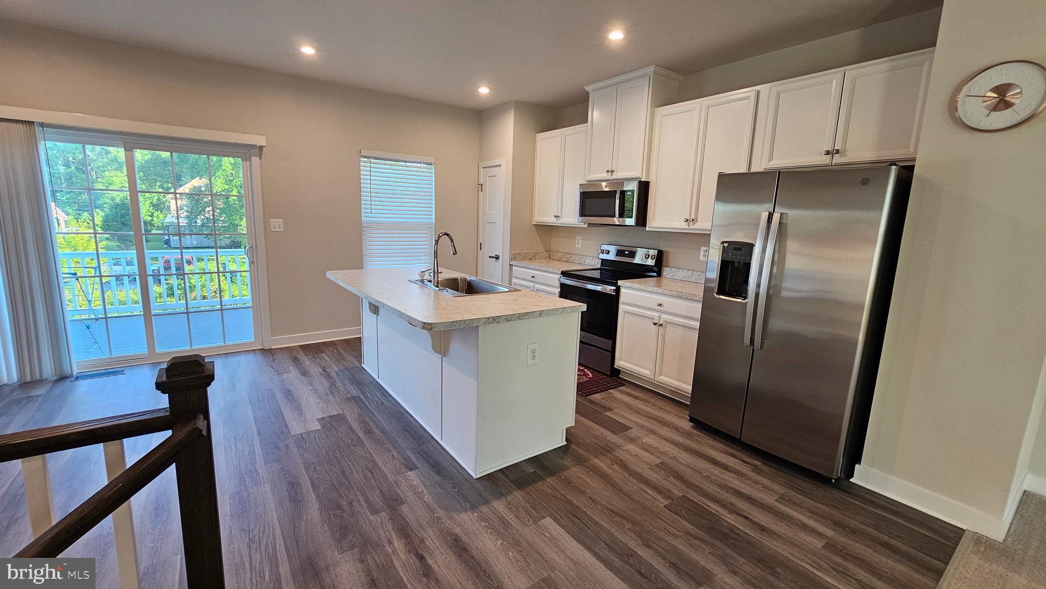 2055 Rivers Drive Newark, DE 19702 - Photo 21 of 48 a kitchen with stainless steel appliances a refrigerator a sink a stove a refrigerator white cabinets and wooden floor