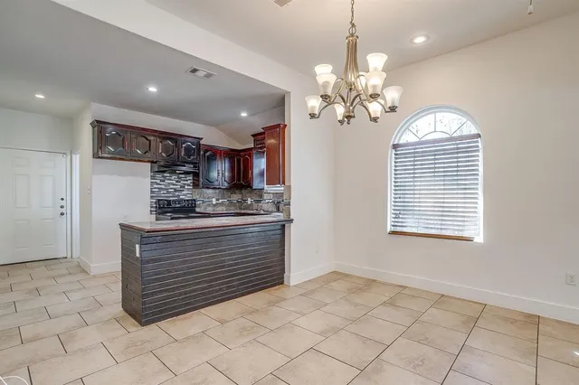 a view of kitchen center island cabinets and stove