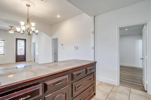 a view of a hallway with granite countertop furniture and chandelier
