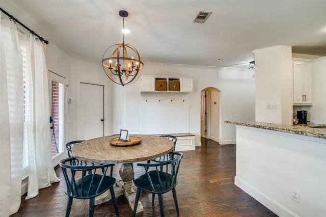 a view of a dining room with furniture wooden floor and a chandelier