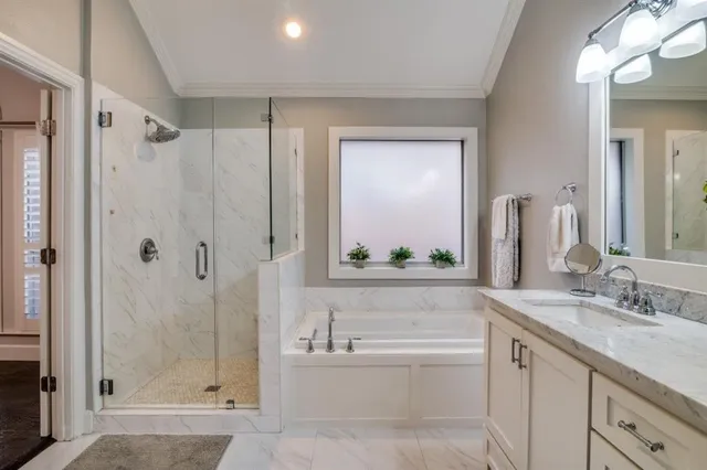 a bathroom with a granite countertop sink mirror and shower