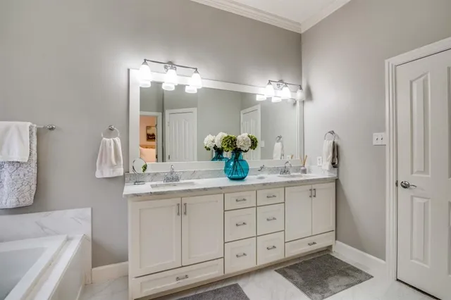 a bathroom with a double vanity sink and a mirror