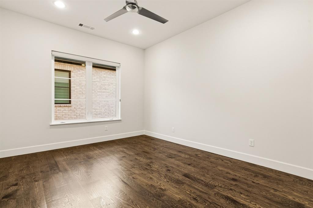 6523 Northwood Road Dallas, TX 75225 - Photo 30 of 36 an empty room with wooden floor and windows