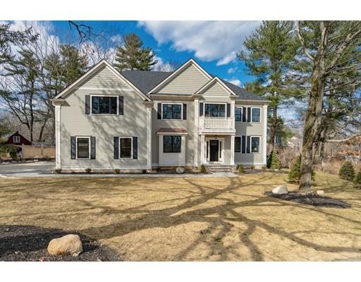 16 Woodcliffe Road Lexington, MA 02421 - Photo 1 of 30 a view of a white house with a small yard and large trees