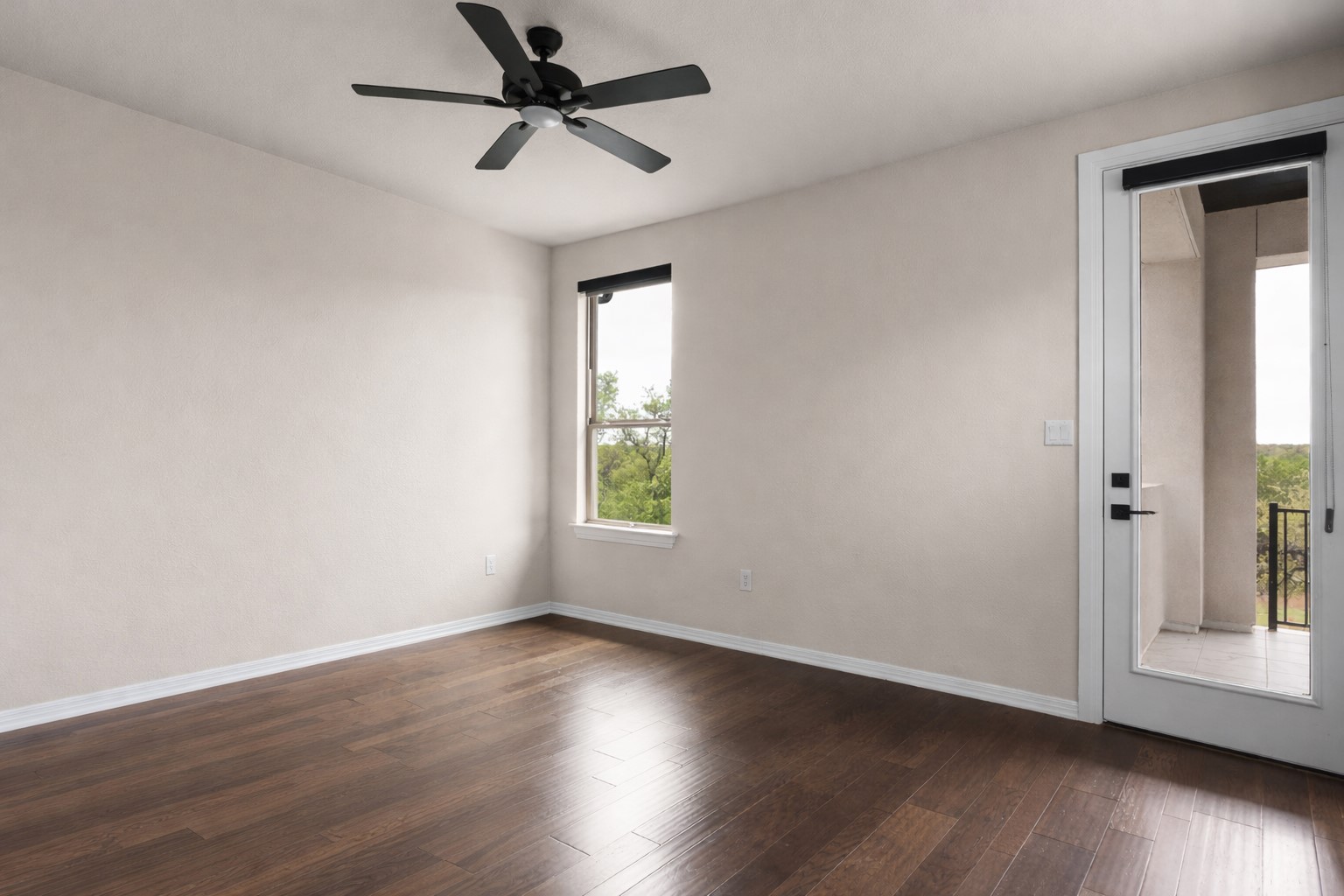 546 Bridge Water Loop Dripping Springs, TX 78620 - Photo 29 of 40 an empty room with wooden floor fan and windows