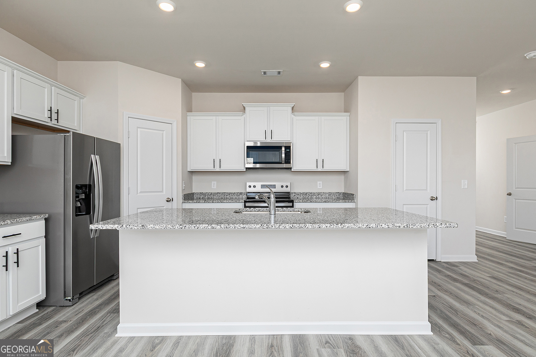 645 Mackenzie Cove Villa Rica, GA 30180 - Photo 11 of 20 a large kitchen with stainless steel appliances granite countertop a stove a sink and a refrigerator