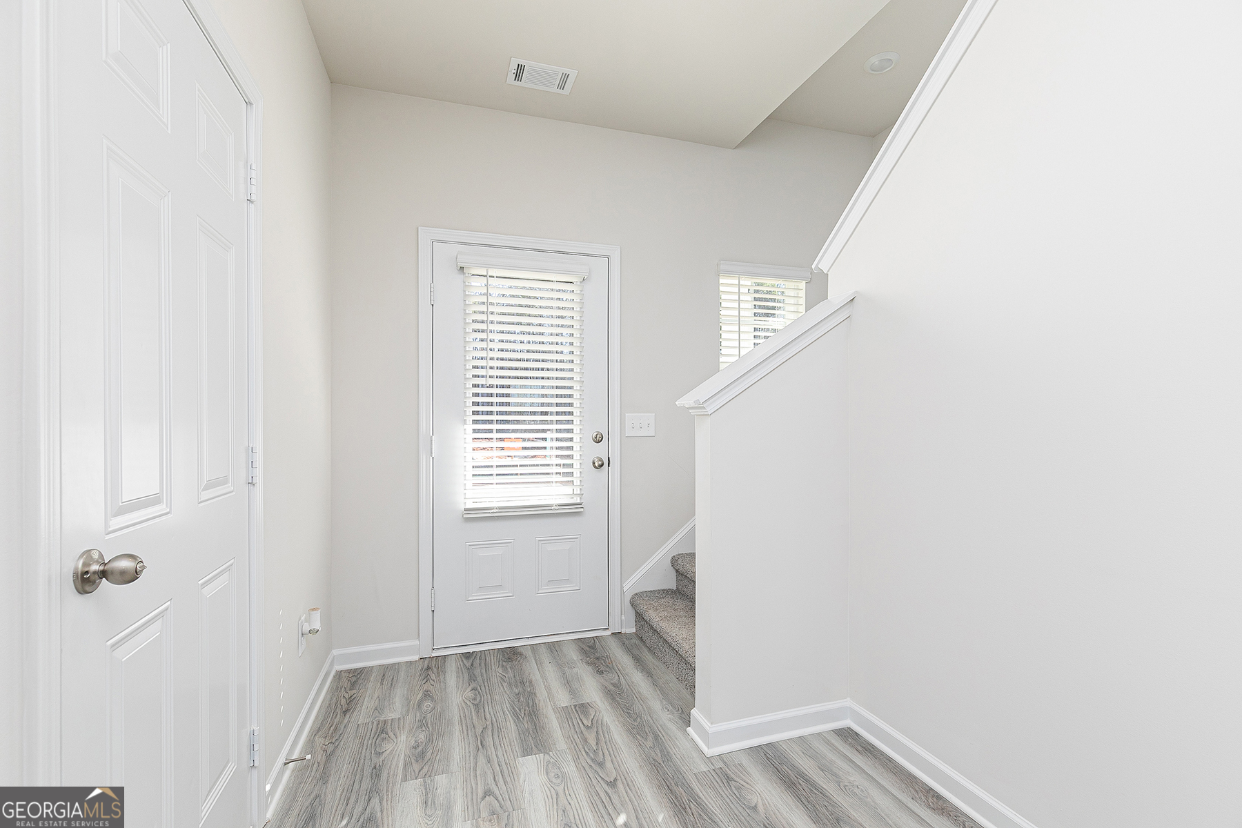 645 Mackenzie Cove Villa Rica, GA 30180 - Photo 3 of 20 a view of an empty room with a window and wooden floor
